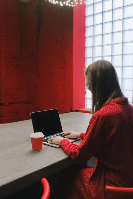 Dual monitors on a desk, showcasing web design in a modern office setting.